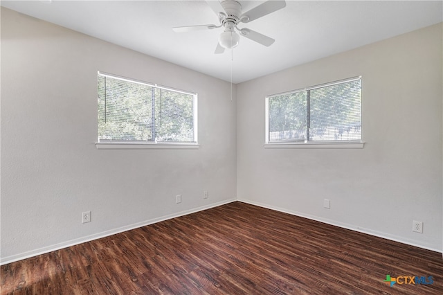 unfurnished room with ceiling fan and dark hardwood / wood-style flooring