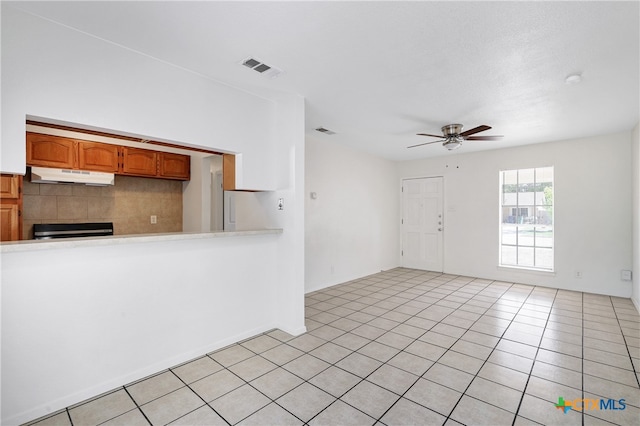 kitchen featuring black stove, ceiling fan, and light tile patterned flooring