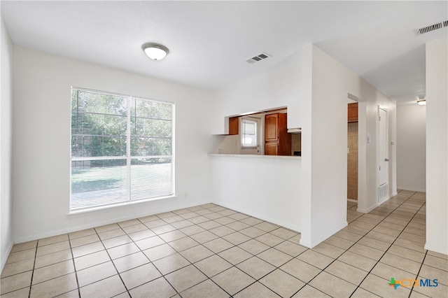 unfurnished room with light tile patterned flooring