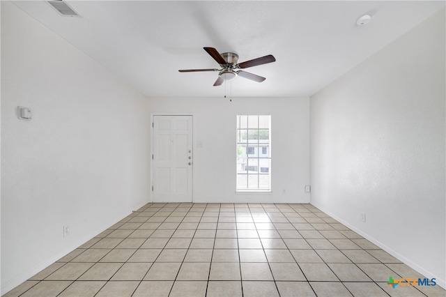 spare room with light tile patterned flooring and ceiling fan