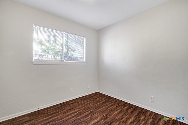 empty room with dark hardwood / wood-style floors