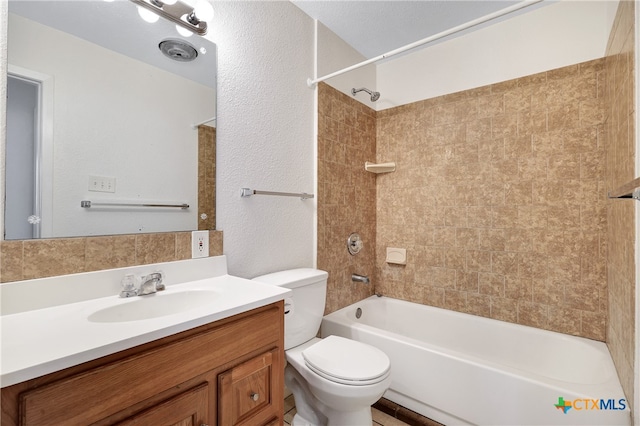 full bathroom featuring vanity, toilet, and tiled shower / bath