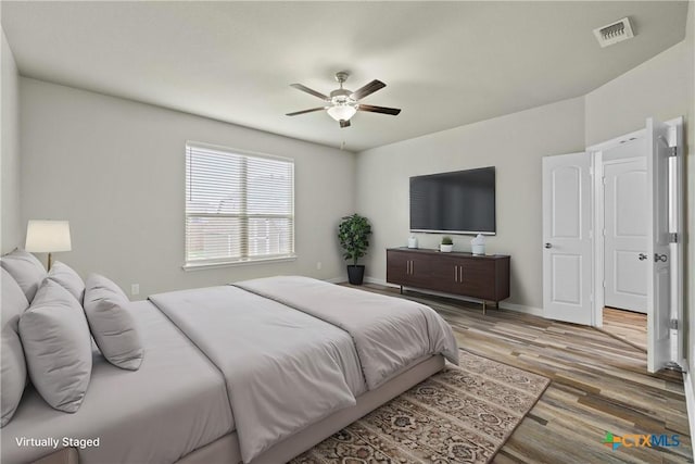 bedroom with ceiling fan and hardwood / wood-style floors