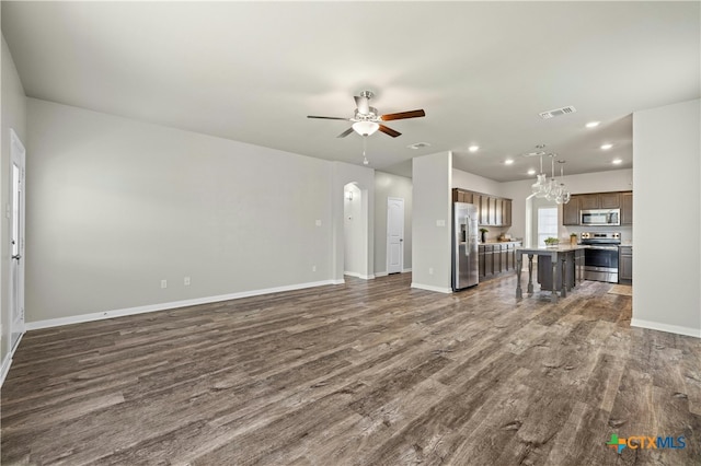 unfurnished living room with dark hardwood / wood-style floors and ceiling fan