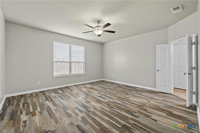 empty room featuring ceiling fan and dark hardwood / wood-style floors