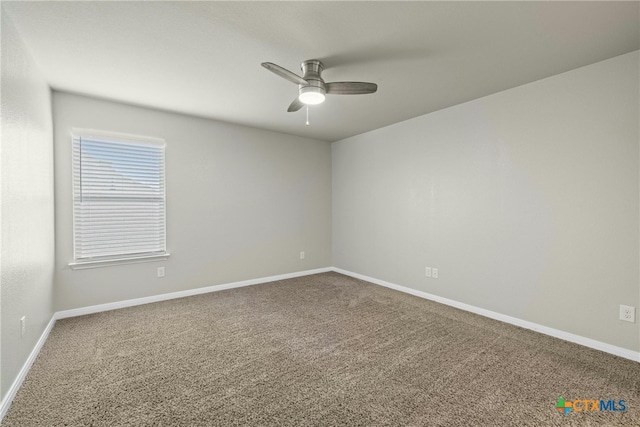 carpeted spare room with ceiling fan