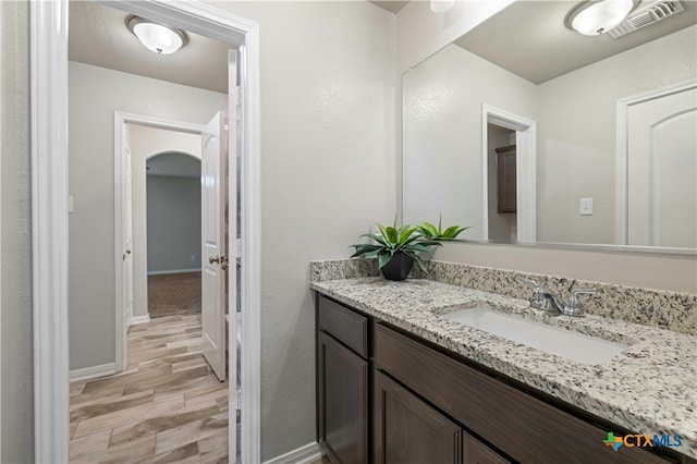 bathroom featuring wood-type flooring and vanity