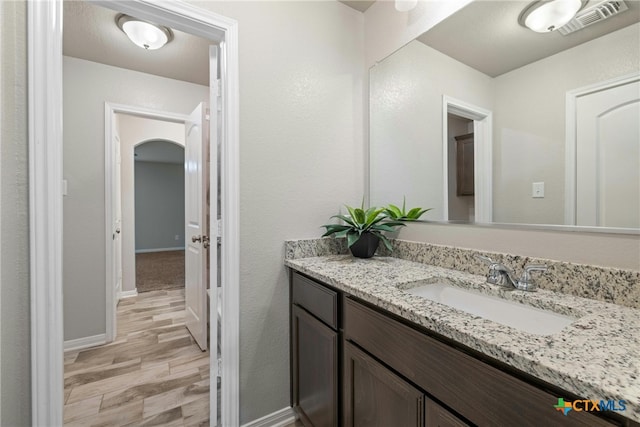 bathroom with hardwood / wood-style floors and vanity