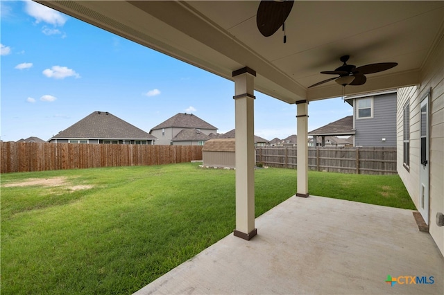 view of yard featuring a patio area and ceiling fan