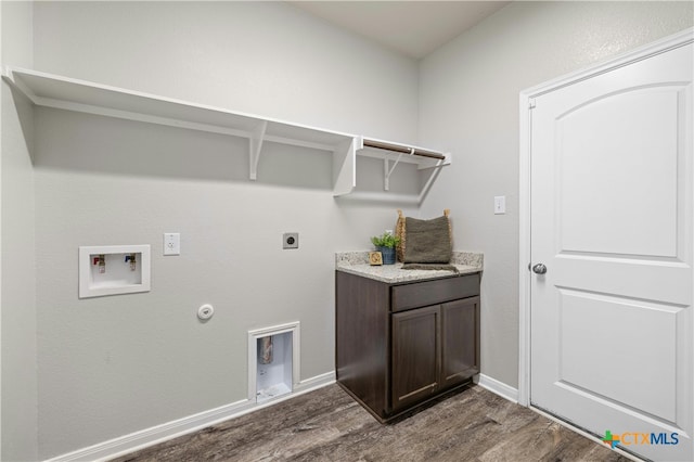 laundry room with electric dryer hookup, cabinets, gas dryer hookup, washer hookup, and dark hardwood / wood-style flooring