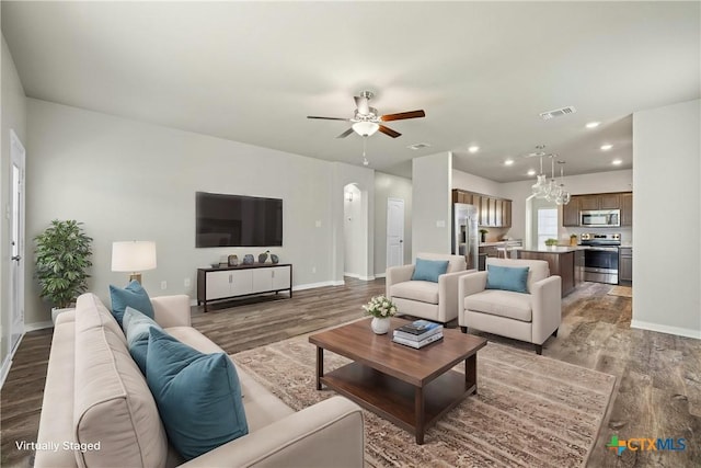 living room with wood-type flooring and ceiling fan