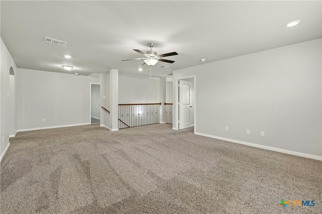 carpeted empty room featuring ceiling fan