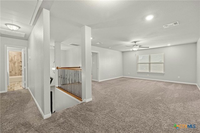 unfurnished room featuring light carpet and ceiling fan