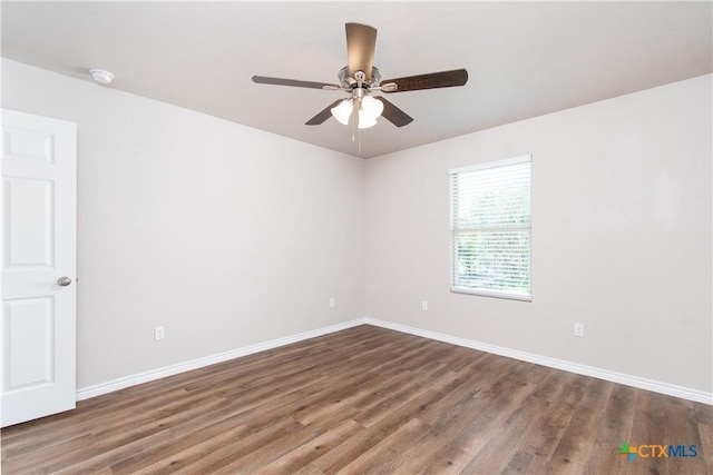 spare room featuring ceiling fan and dark hardwood / wood-style flooring