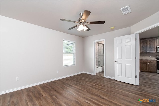 unfurnished bedroom featuring ensuite bath, ceiling fan, and dark hardwood / wood-style flooring