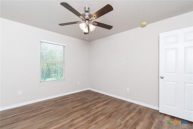 empty room featuring dark hardwood / wood-style floors and ceiling fan