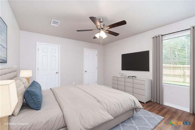 bedroom featuring dark hardwood / wood-style flooring and ceiling fan