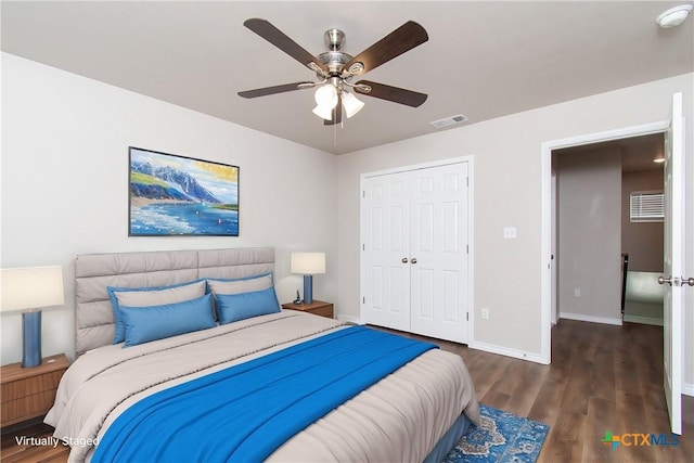 bedroom with dark hardwood / wood-style flooring, ceiling fan, and a closet