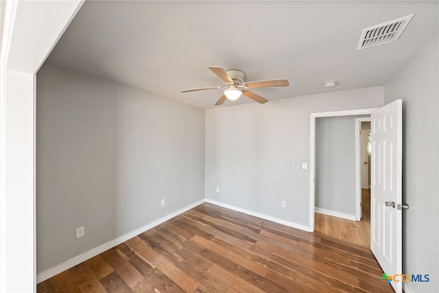 unfurnished room with ceiling fan and dark hardwood / wood-style floors