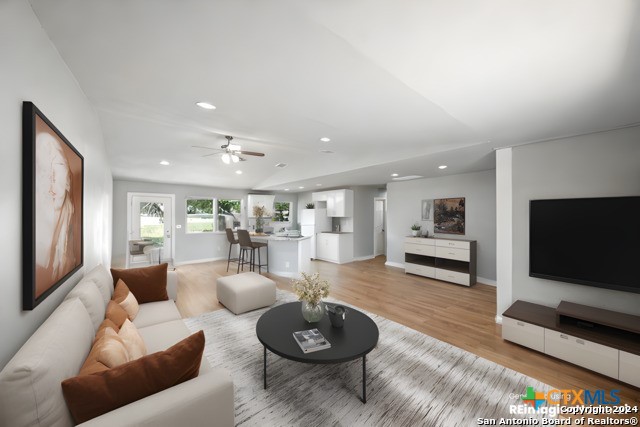 living room featuring ceiling fan and light wood-type flooring