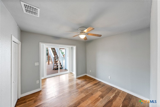 spare room with wood-type flooring and ceiling fan