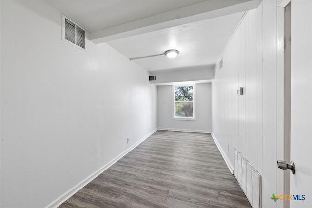 hall with beamed ceiling and wood-type flooring