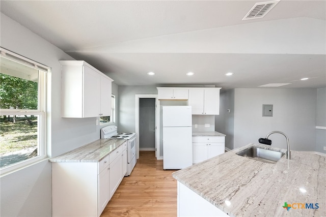 kitchen with white cabinets, lofted ceiling, sink, and white appliances