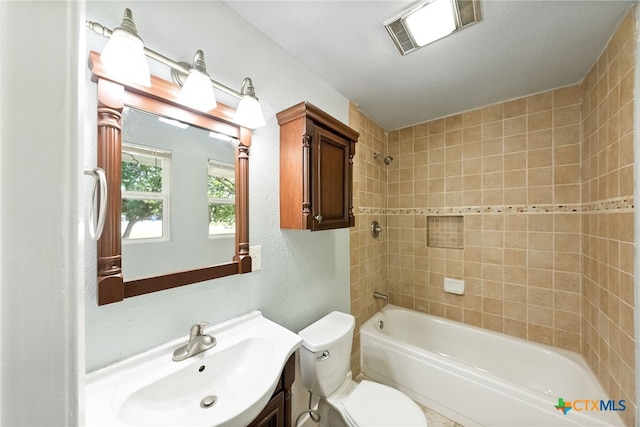 full bathroom with vanity, toilet, and tiled shower / bath combo