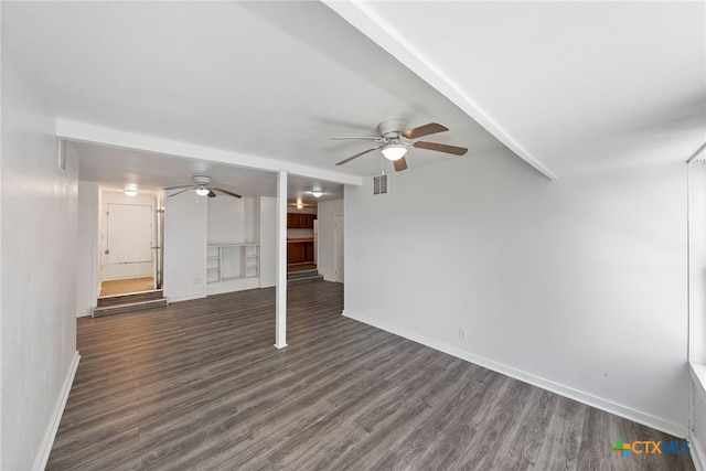 unfurnished living room featuring dark wood-type flooring and ceiling fan