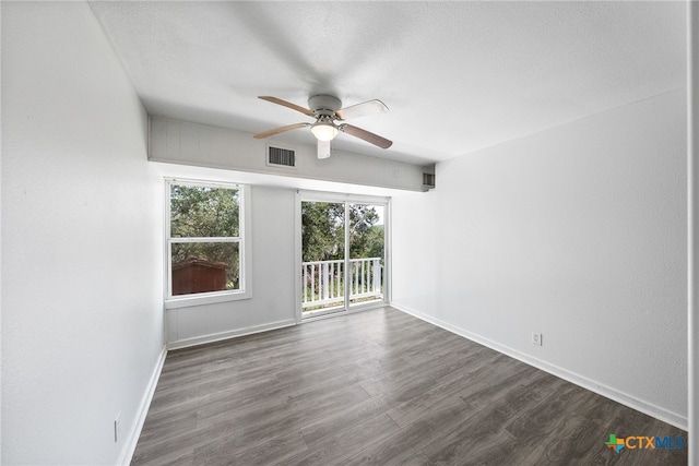 unfurnished room with dark hardwood / wood-style flooring, a textured ceiling, and ceiling fan