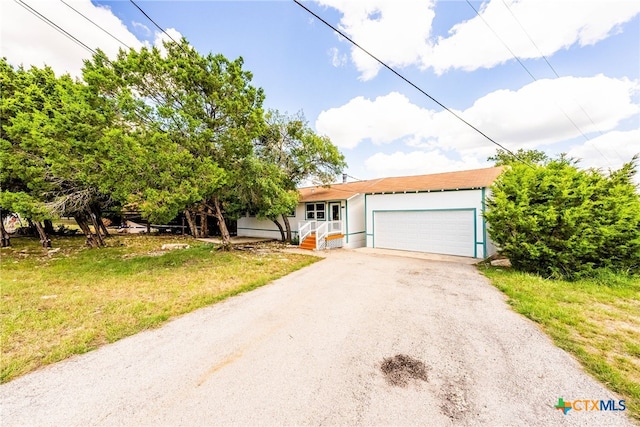 view of front of home featuring a garage and a front yard