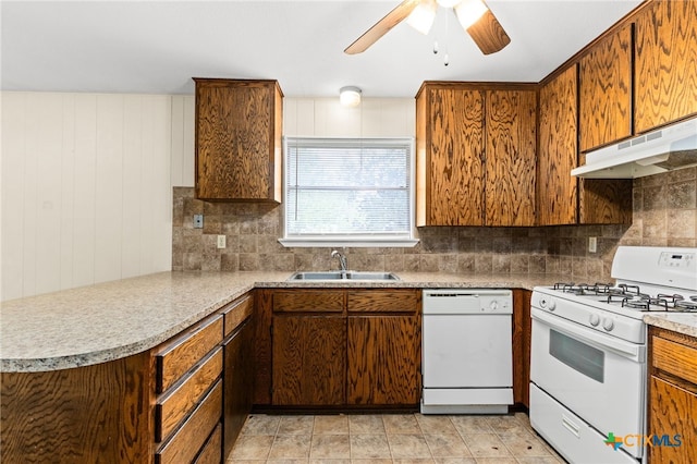 kitchen with under cabinet range hood, backsplash, a sink, white appliances, and ceiling fan