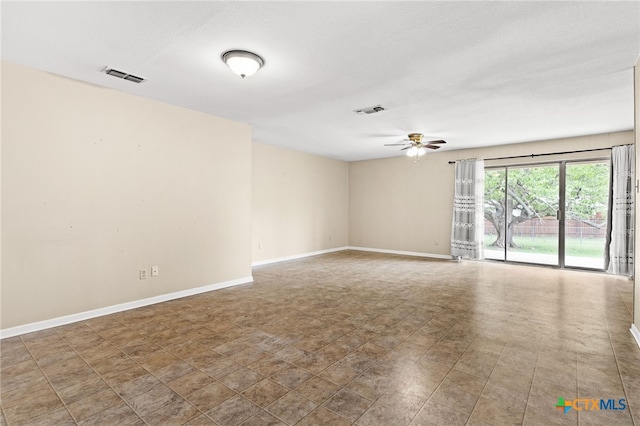 empty room with ceiling fan, baseboards, and visible vents