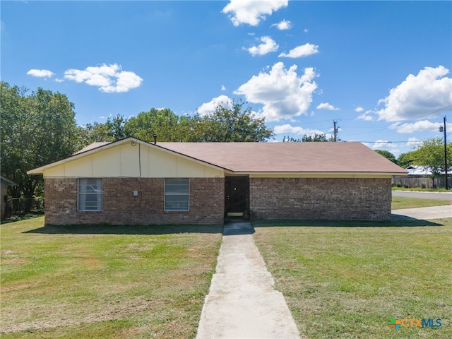 ranch-style house with brick siding and a front yard