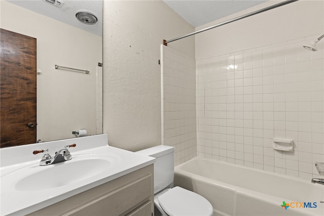 bathroom with a textured ceiling, toilet, shower / bath combination, a textured wall, and vanity