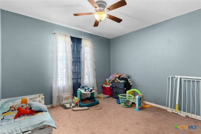 carpeted bedroom featuring ceiling fan and a textured ceiling