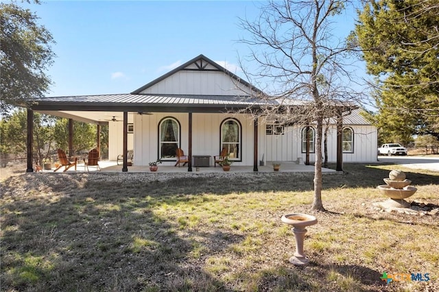 view of front of house with a front yard and a patio area