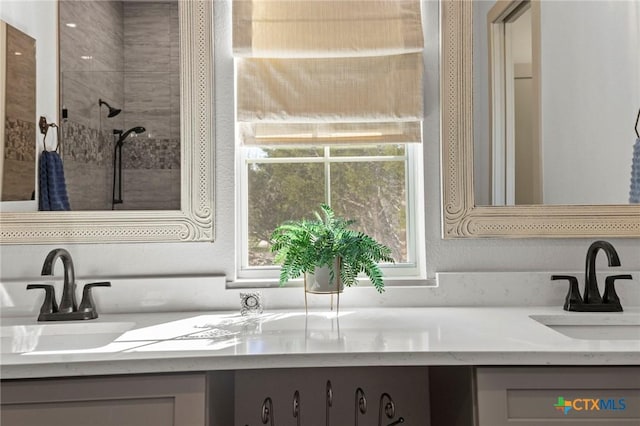 bathroom featuring vanity and tiled shower