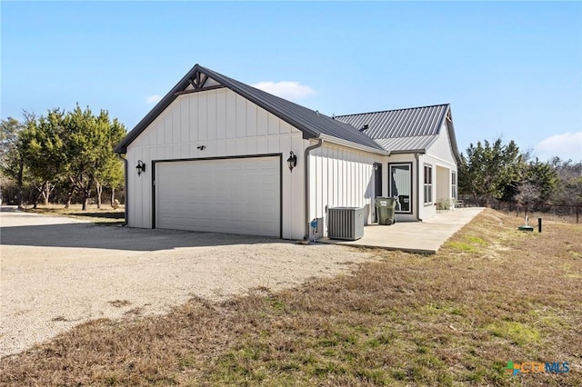 view of home's exterior featuring a garage, central AC unit, and a patio area