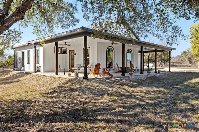 exterior space featuring a lawn, ceiling fan, and a patio area