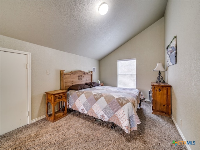 bedroom featuring carpet floors, vaulted ceiling, and a textured ceiling