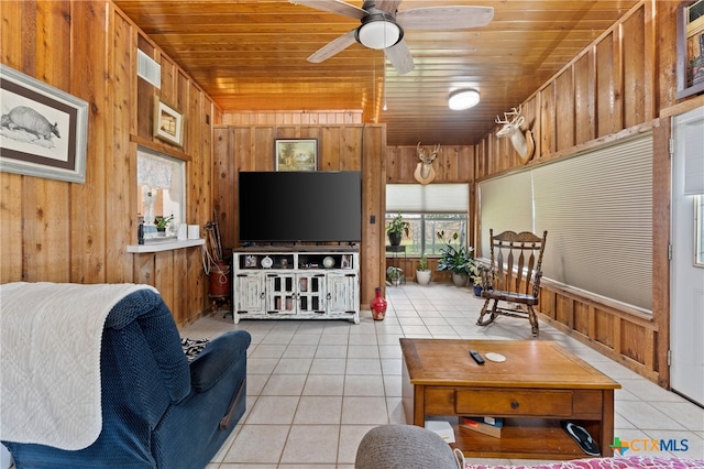 living room featuring wooden walls, wood ceiling, and light tile patterned floors