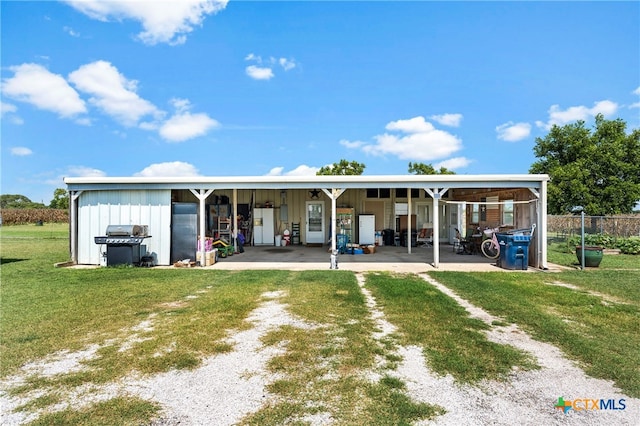 rear view of property featuring a lawn