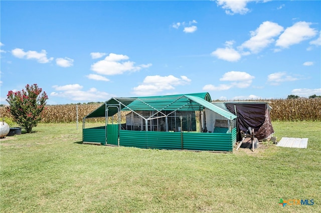 back of house with a lawn