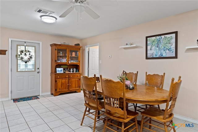 dining space with ceiling fan and light tile patterned floors