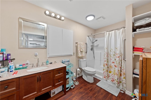 bathroom with hardwood / wood-style floors, vanity, curtained shower, and toilet