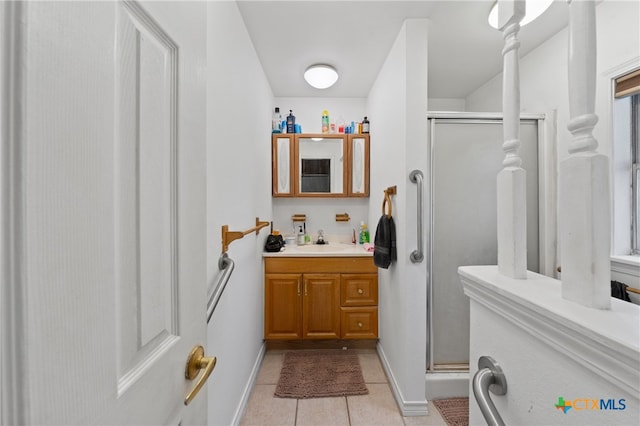 bathroom featuring vanity, walk in shower, and tile patterned floors