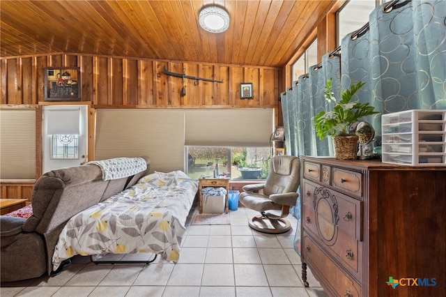 bedroom with wood walls, wood ceiling, and light tile patterned floors