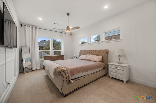 bedroom with ceiling fan and light colored carpet