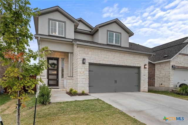 view of front of home featuring a front lawn and a garage